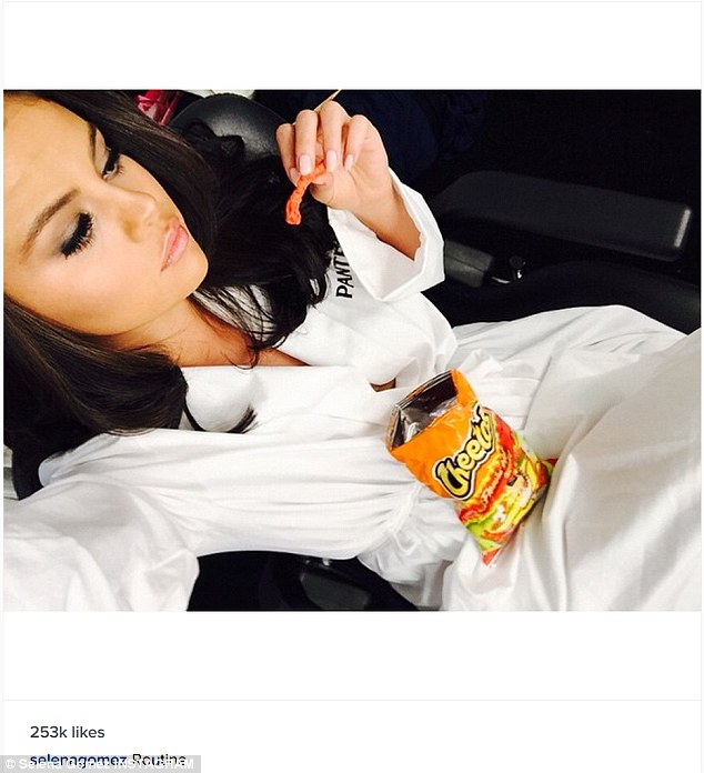 Selena Gomez shares photo where she's snacking on Flaming Hot Cheetos amid  weight criticism | Daily Mail Online